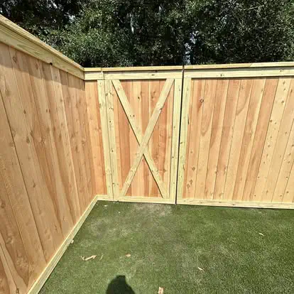 A new wood fence with a cross braced gate